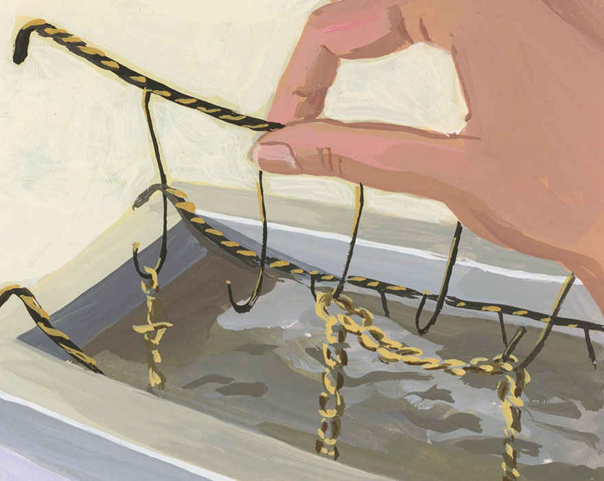Hand dipping a golden chain into a finishing bath